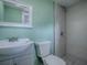 This bathroom features a modern vanity, tiled shower and green walls at 8901 Se 144Th Ln, Summerfield, FL 34491