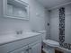 This bathroom features a modern vanity, tiled shower with decorative accent and tiled floors at 8901 Se 144Th Ln, Summerfield, FL 34491