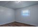 Minimalist bedroom with wood-look flooring, window with sheer curtain providing natural light at 8901 Se 144Th Ln, Summerfield, FL 34491