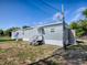 Charming single story home with white trim, siding, and a small yard at 8901 Se 144Th Ln, Summerfield, FL 34491
