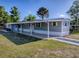 Charming single-story home with covered patio and landscaped front yard, ideal for outdoor living at 8901 Se 144Th Ln, Summerfield, FL 34491
