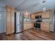 Modern kitchen with stainless steel appliances, light wood cabinets, and stylish countertops for a functional space at 8901 Se 144Th Ln, Summerfield, FL 34491