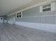 Spacious covered patio featuring neutral flooring, providing ample outdoor living and entertaining space at 8901 Se 144Th Ln, Summerfield, FL 34491