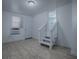 Bright room features tile flooring, and stairs with a baby gate at the top of them at 8901 Se 144Th Ln, Summerfield, FL 34491