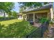 Fenced backyard with lush lawn, patio and screened porch is ideal for outdoor gatherings and relaxation at 1001 Harmony Ln, Clermont, FL 34711