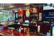 A well-stocked bar featuring liquor displays, TV screens, and a polished wooden bar top at 1001 Harmony Ln, Clermont, FL 34711