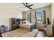 Well-lit bedroom with hardwood floors, a ceiling fan, and two large windows, creating a bright and inviting atmosphere at 1001 Harmony Ln, Clermont, FL 34711