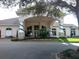 Clubhouse featuring a welcoming entrance, beautiful landscaping, and architectural details at 1001 Harmony Ln, Clermont, FL 34711