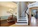 Inviting foyer features beautiful staircase and seamlessly connects to the dining area with stylish chandelier at 1001 Harmony Ln, Clermont, FL 34711