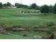 Golf course view with a water feature and the name 'LEGENDS' built on a grassy hillside at 1001 Harmony Ln, Clermont, FL 34711