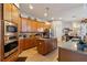 Spacious kitchen with stainless steel appliances, granite countertops, and ample wood cabinetry at 1001 Harmony Ln, Clermont, FL 34711