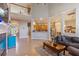 Bright living room with fireplace, staircase, and view into kitchen with breakfast bar at 1001 Harmony Ln, Clermont, FL 34711