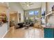 Open-concept living room with high ceilings, large windows, tile flooring, and a cozy fireplace at 1001 Harmony Ln, Clermont, FL 34711