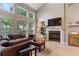 Spacious living room featuring a fireplace, large windows, and comfortable seating at 1001 Harmony Ln, Clermont, FL 34711
