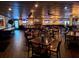 Restaurant interior with hardwood floors, dark wood tables and chairs, and multiple TVs at 1001 Harmony Ln, Clermont, FL 34711