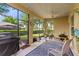 Enjoy the outdoors in this spacious screened porch with a ceiling fan and ample seating area at 1001 Harmony Ln, Clermont, FL 34711
