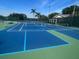 Outdoor tennis and pickleball courts featuring blue and green surfaces, nets, and perimeter fencing at 1001 Harmony Ln, Clermont, FL 34711