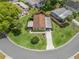 Aerial view of a well-kept single Gathering home with beautiful landscaping and a circular driveway in a tranquil setting at 1003 Parker Pl, Lady Lake, FL 32159