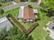 Aerial view of a single Gathering home highlighting its manicured yard and convenient access to neighborhood streets at 1003 Parker Pl, Lady Lake, FL 32159