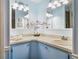 Well-lit bathroom featuring vanity, decorative mirrors, and updated fixtures at 1003 Parker Pl, Lady Lake, FL 32159