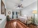 Comfortable bedroom featuring wood floors, ceiling fan and decorative decor at 1003 Parker Pl, Lady Lake, FL 32159