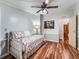 Stylish bedroom with wood floors, ceiling fan, and natural light at 1003 Parker Pl, Lady Lake, FL 32159