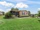 Single-story home featuring an inviting screened-in porch and lovely landscaping in a peaceful neighborhood at 1003 Parker Pl, Lady Lake, FL 32159