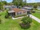 Well-maintained single-story home with manicured landscaping and inviting screened-in porch in a desirable neighborhood at 1003 Parker Pl, Lady Lake, FL 32159