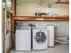 Garage interior features a washer and dryer, a water heater, and shelving for storage at 1003 Parker Pl, Lady Lake, FL 32159