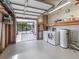 Open garage features a washer and dryer, shelving for storage, and a screened patio area at 1003 Parker Pl, Lady Lake, FL 32159