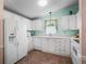 Charming kitchen featuring white appliances and cabinetry at 1003 Parker Pl, Lady Lake, FL 32159