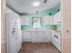 Bright kitchen with white cabinetry and appliances at 1003 Parker Pl, Lady Lake, FL 32159