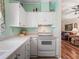 Practical kitchen design with white cabinets and appliances, open to the living area at 1003 Parker Pl, Lady Lake, FL 32159