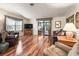 Spacious living room featuring hardwood floors, comfortable seating, and sliding glass doors to the outdoor space at 1003 Parker Pl, Lady Lake, FL 32159