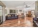 Cozy living room with hardwood floors, leather furniture, and lots of natural light at 1003 Parker Pl, Lady Lake, FL 32159