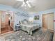 Spacious primary bedroom with a blue accent wall and lots of natural light at 1003 Parker Pl, Lady Lake, FL 32159