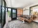 Sunroom with tile flooring features cushioned wicker furniture and a sliding door that provides backyard access at 1003 Parker Pl, Lady Lake, FL 32159