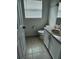 A half bathroom with neutral tile flooring and a single vanity with laminate countertop at 1040 Soaring Eagle Ln, Kissimmee, FL 34746