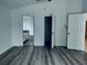 Bedroom with vinyl floors and access to the bathroom and closet at 1040 Soaring Eagle Ln, Kissimmee, FL 34746