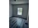 Bedroom with vinyl floors and window facing the backyard at 1040 Soaring Eagle Ln, Kissimmee, FL 34746