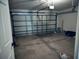 Spacious garage with a roll-up door and concrete floor at 1040 Soaring Eagle Ln, Kissimmee, FL 34746