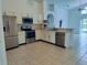 Spacious kitchen featuring stainless steel appliances, a breakfast bar, and an open layout for easy entertaining at 1040 Soaring Eagle Ln, Kissimmee, FL 34746