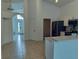 Open-concept kitchen features stainless steel appliances, white cabinets, and tile flooring at 1040 Soaring Eagle Ln, Kissimmee, FL 34746