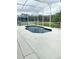 Screened-in pool area with an in-ground pool surrounded by a concrete deck at 1040 Soaring Eagle Ln, Kissimmee, FL 34746