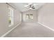 Spacious bedroom featuring vaulted ceiling, carpet flooring, and natural light at 10460 Silver Maple Ave, Oxford, FL 34484