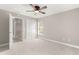 Bedroom featuring neutral walls, carpet, a closet, and a doorway leading to the hallway at 10460 Silver Maple Ave, Oxford, FL 34484