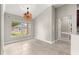 Dining room featuring vaulted ceiling, bright windows, and neutral paint at 10460 Silver Maple Ave, Oxford, FL 34484