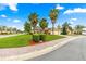 Single-story home boasts a brick-paved driveway, mature palm trees, green lawn, and tasteful landscaping at 10460 Silver Maple Ave, Oxford, FL 34484