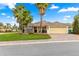 Beautiful home with palm trees, a lush green lawn, and a well-maintained brick driveway at 10460 Silver Maple Ave, Oxford, FL 34484