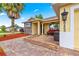 Charming single-story home with a brick-paved patio featuring outdoor seating and stone detailing at 10460 Silver Maple Ave, Oxford, FL 34484